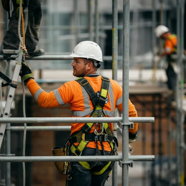 man on scaffolding by roof